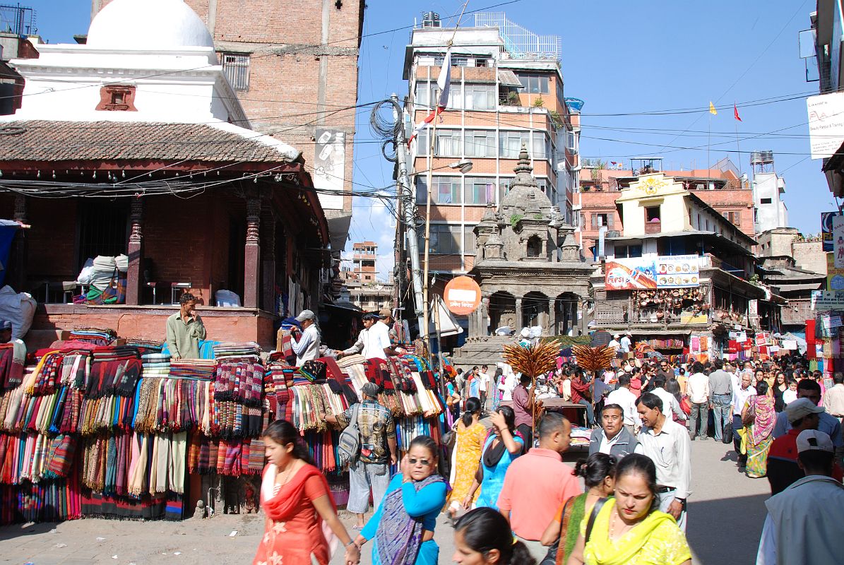 Kathmandu 05 02-1 Indra Chowk Merchants sell pashmina and other fabric shawls and other cloth goods next to the shikira-style Shiva temple in Indra Chowk in Kathmandu.